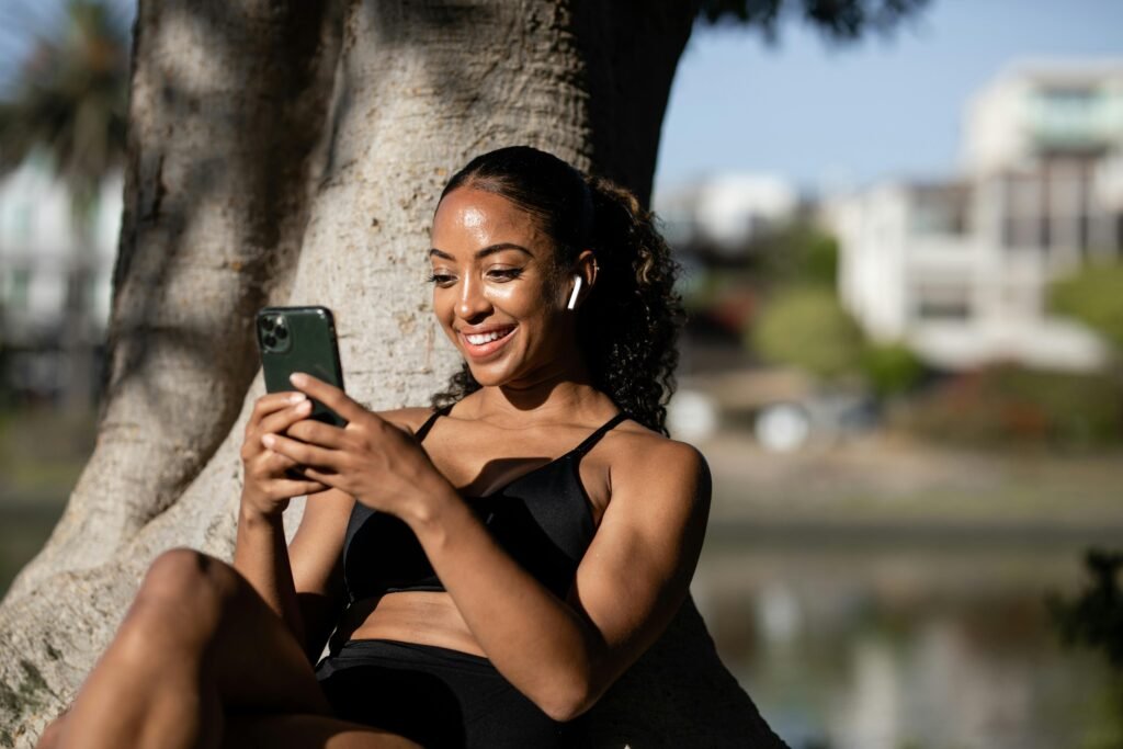 Happy woman holding a smartphone after winning iPhone 15 Pro USA giveaway
